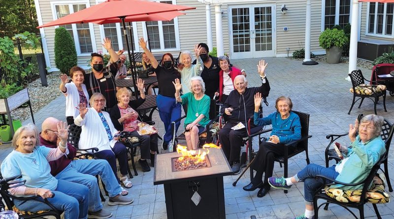 Residents enjoy some social time outside an Arbors facility.